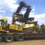 DARK METALS loads oversized pieces of redundant earthmoving machinery onto lowbeds for transportation
to its' facilities for complete processing.