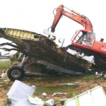 Excavator sits on wing section in order to have better access to main fuel tanks for breaking.
